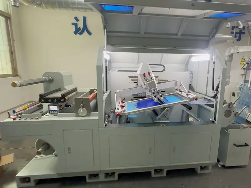 Close-up of a screen printing station inside an automatic printing machine