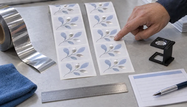 Illustrative foil trial workbench with two strips of the same label artwork, foil film and inspection tools