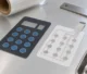 Illustration of a membrane-switch graphic overlay and a separate silver-printed circuit film on an inspection bench